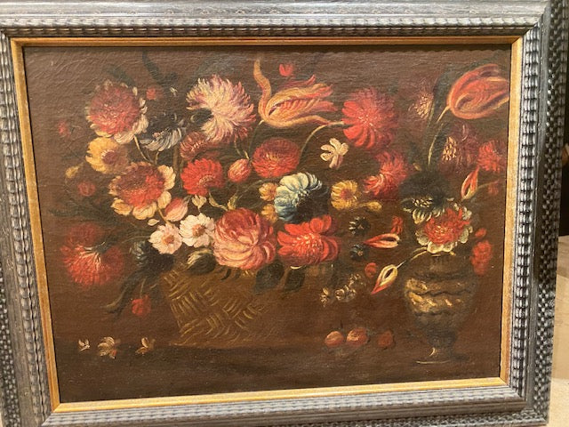 A canvas painting featuring a floral still-life with a basket and vase of flowers, set against a dark background, framed in a traditional Dutch black ripple frame.